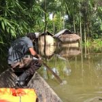 Image 7: TCF team reaching out to one of the flooded villages in its boat.