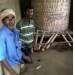 Image 9: TCF team helped this villager to protect the food grains from increasing flood waters.