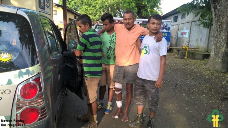 Image 6: A villager injured in a wild boar attack is being taken to hospital by TCF team.