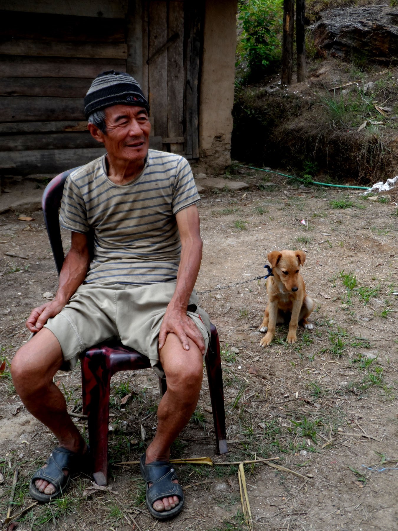 An elderly sits with his pup for its anti-rabies vaccination